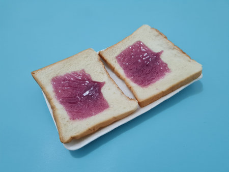 Bread made from flour and other ingredients with spread or filling with blueberry jam