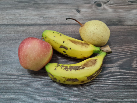 Fresh fruit consisting of red apples, yellow bananas and pearsの写真素材