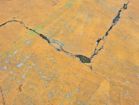 Yellow basketball court abstract background with cracksの写真素材
