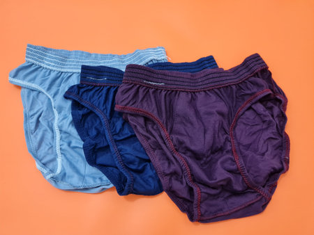 Men's underpants in red, blue and gray made of threadの写真素材