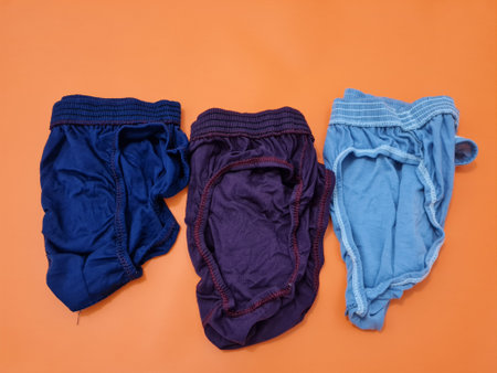 Men's underpants in red, blue and gray made of threadの写真素材