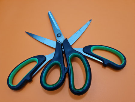 Scissors with green handles, useful for cutting paper or other materialsの写真素材