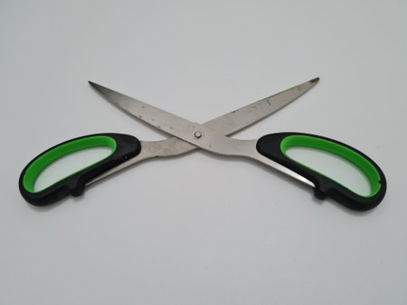 Scissors with green handles, useful for cutting paper or other materialsの写真素材