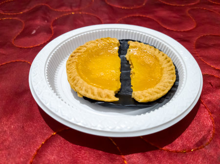 Soft sweet milk pie in a white container on a red cloth backgroundの写真素材