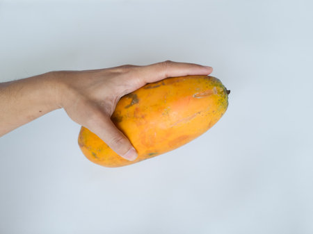 Ripe papaya that has not been peeled has a yellow-green skin colorの写真素材