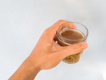 Brown cooked green bean drink in a glass cup is good for maintaining body healthの写真素材