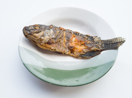Fried fish in a plate on a white background, top viewの写真素材
