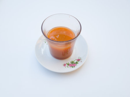 Orange carrot juice drink in a glass cupの写真素材