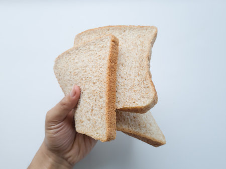 Slices of plain wheat bread, either eaten straight away or topped with chocolate or something elseの写真素材