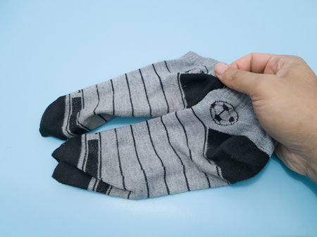 striped socks for clothing on a blue background, close-upの写真素材