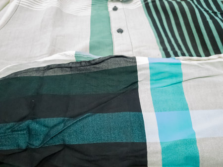Close-up of white and blue stripes on black and white t-shirts
