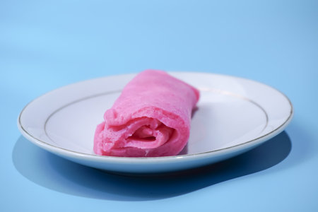 Indonesian market snacks are red sweet rolled pancakesの写真素材