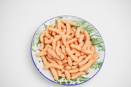 A dry snack made from flour and sesame in an oval shape is called keciputの写真素材