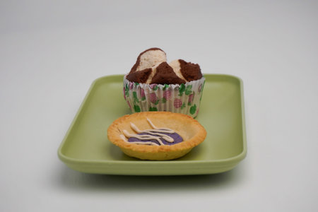 Cupcake on a green plate on a white background, isolateの写真素材