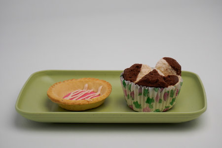 Cupcake on a green plate on a white background, isolateの写真素材