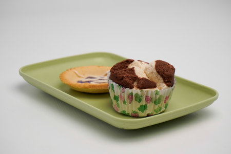 Cupcake on a green plate on a white background, isolateの写真素材