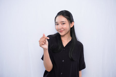 Asian woman expression in black dress smiling on white backgroundの写真素材