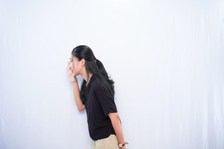 Expression of Asian woman in black dress whispering on white backgroundの写真素材