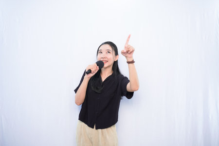 Expression of Asian woman in black dress singing with white backgroundの写真素材