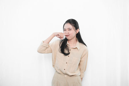 Expression of model woman in white dress holding back unpleasant odor