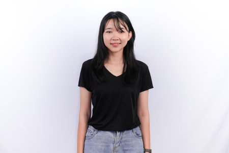 Indonesian Asian woman in black top standing straightの写真素材