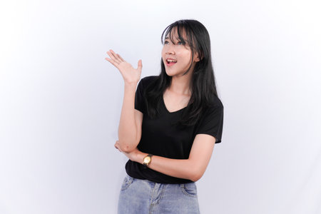 Asian Indonesian woman wearing black top and jeans imagining somethingの写真素材
