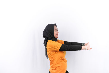 Indonesian woman in yellow dress doing sports