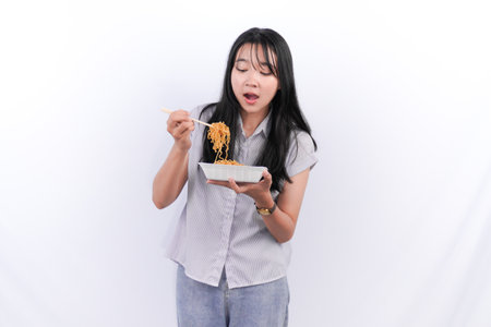 Asian Indonesian woman eating noodlesの写真素材