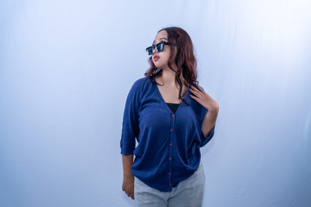 Indonesian Asian woman in blue dress wearing sunglasses and looking up