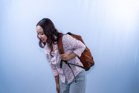 Indonesian Asian woman in white floral shirt with bag going on holiday