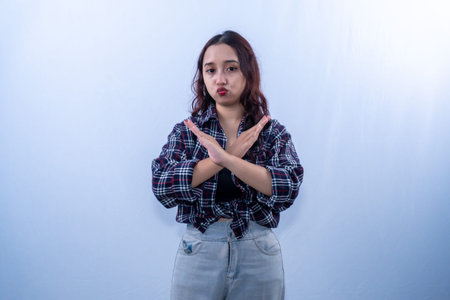 Indonesian Asian woman in plaid shirt with her arms crossedの写真素材