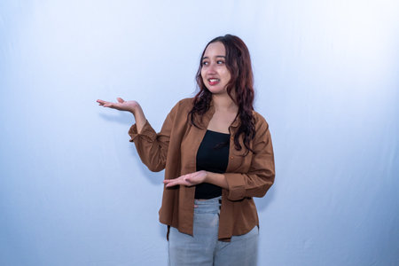 An Indonesian woman in a brown dress smiled and invited me in.の写真素材