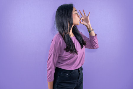 Indonesian Asian woman wearing purple clothesの写真素材