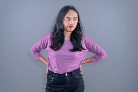 Indonesian Asian woman wearing purple clothes with disappointed expressionの写真素材