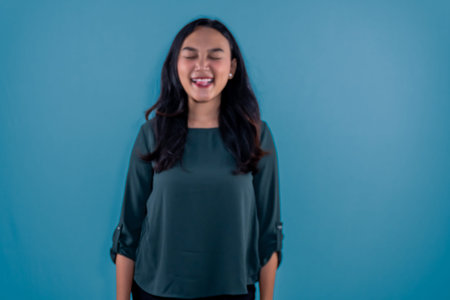 Asian Indonesian woman wearing green clothes standing straight