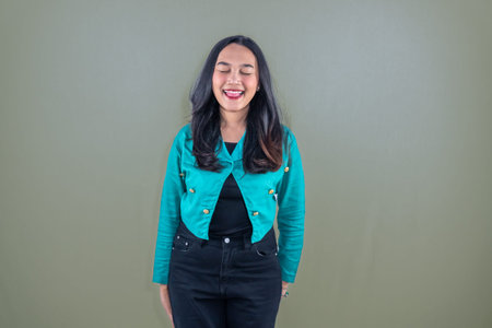 Asian Indonesian woman wearing navy dress smiling and closing her eyes