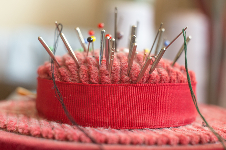 pincushion with lot of needles and pins for sewingの写真素材