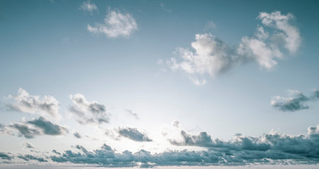 blue sky with fluffy clouds at sunrise