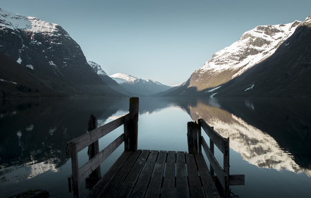 Old wooden pier at the lake in Norwayの写真素材