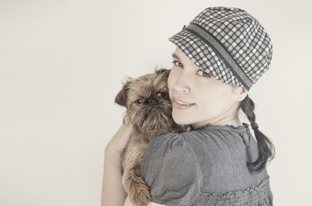 Young attractive woman with dog on her handsの写真素材