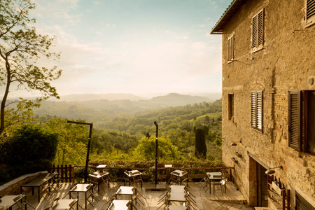 Restaurant in San Gimignano town with beautiful view on Tuscany, Italyの写真素材