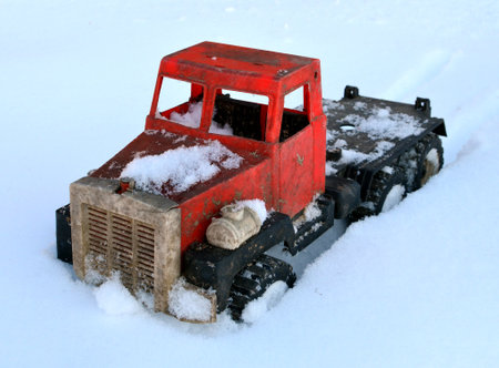 A toy truck trapped in the snow, closeup shot, concept of driving in winterの写真素材