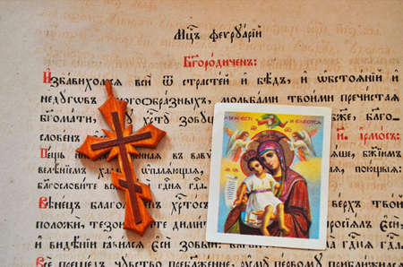 December. 2019. Lviv. Ukraine. Revealed Bible and Christian symbols: cross, icon, rosary.のeditorial素材
