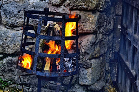 A fire from burning brews in the basket. Ritual fire.の写真素材