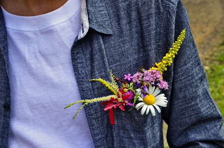 flowers in shirt pocket. Summer flowers in shirt pocket. Ecology concept.の写真素材