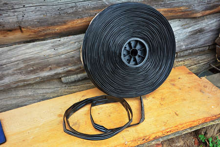 Roll of watering tape with emitters for installation of drip system of plants.の写真素材