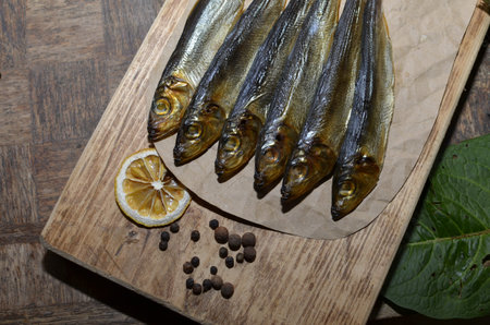 Delicious smoked salmon herring beautifully garnished on a rustic wooden table