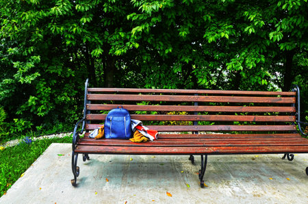 Bag (backpack, bag) left on a bench in the park.の写真素材