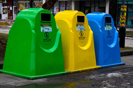 Rivne. Ukraine. March 2021. Multi-colored plastic garbage containers for different garbage are on the street.のeditorial素材