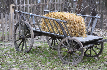 Old wooden cart with wooden wheels in the village.の写真素材